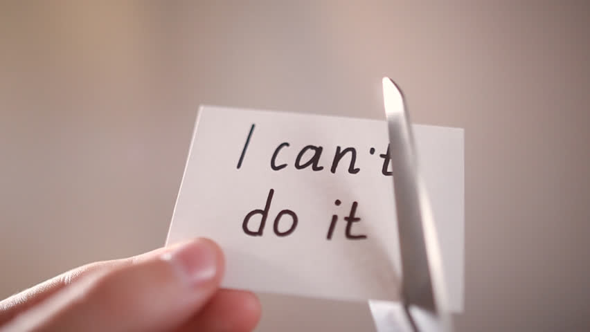 Man using scissors to remove the word can't to read I can do it concept for self belief, positive attitude and motivation | Shutterstock HD Video #18083563