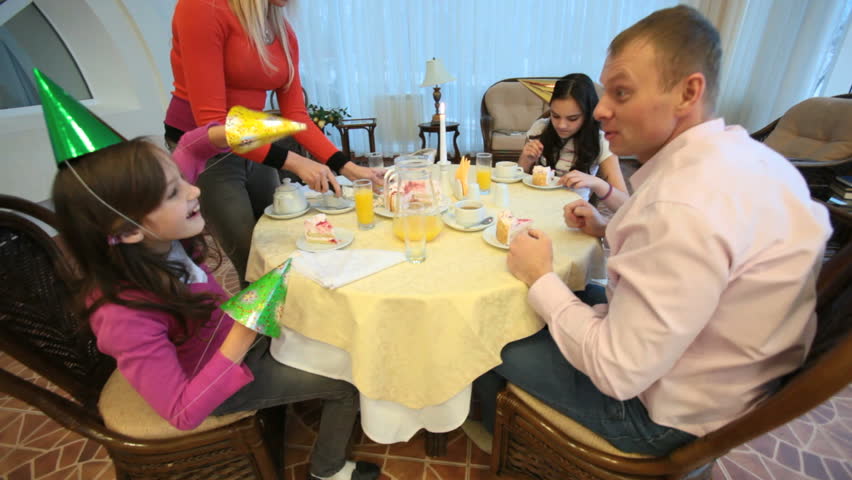 Family of four eating cake