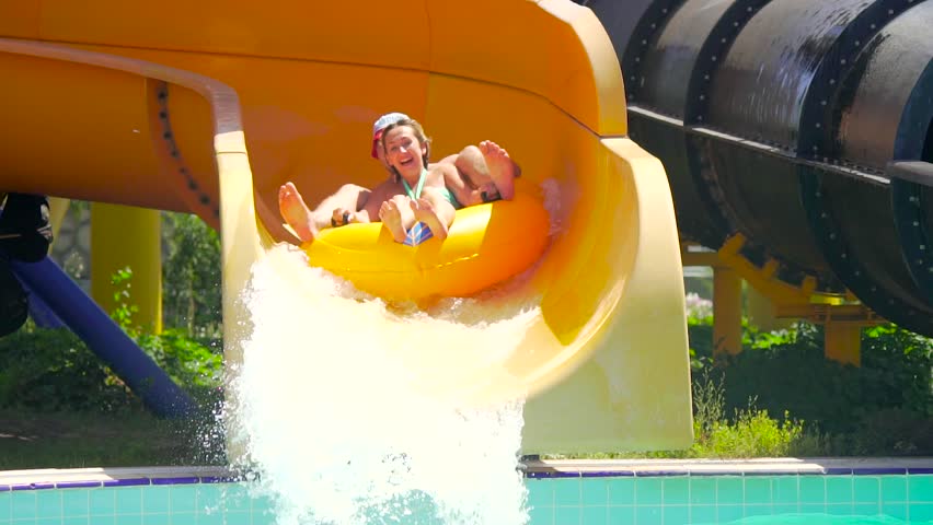 Young couple sliding down from the hill at water park and enjoying it Royalty-Free Stock Footage #18090142