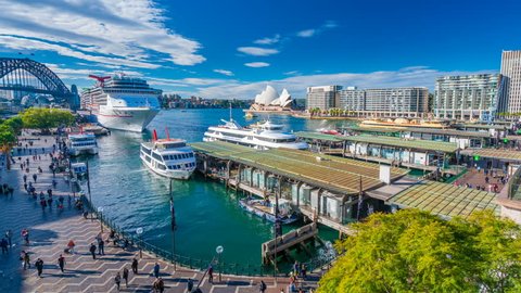 Sydney, Australia - June 23, 2016: 4k hyperlapse video of ferries and people visiting Circular Quay in Sydney CBD, with view of Harbour Bridge and Opera House