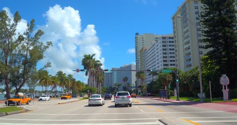 MIAMI BEACH - JULY 17: Drivers pov touring Miami Beach on Collins Avenue which is the easternmost street in Miami Beachshot with a gimbal stabilized car mounted camera July 17, 2016 in Miami Beach FL