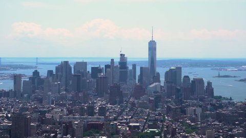 Aerial daytime establishing shot of downtown Manhattan on a hot summer hazy day. View of the financial district, soho, greenwich village, chinatown and little italy
