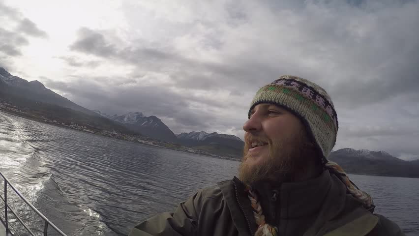 Pleased Man With a Beard Floats in a Boat and Shoots at the Camera a Very Beautiful Landscape Around. Wild Nature