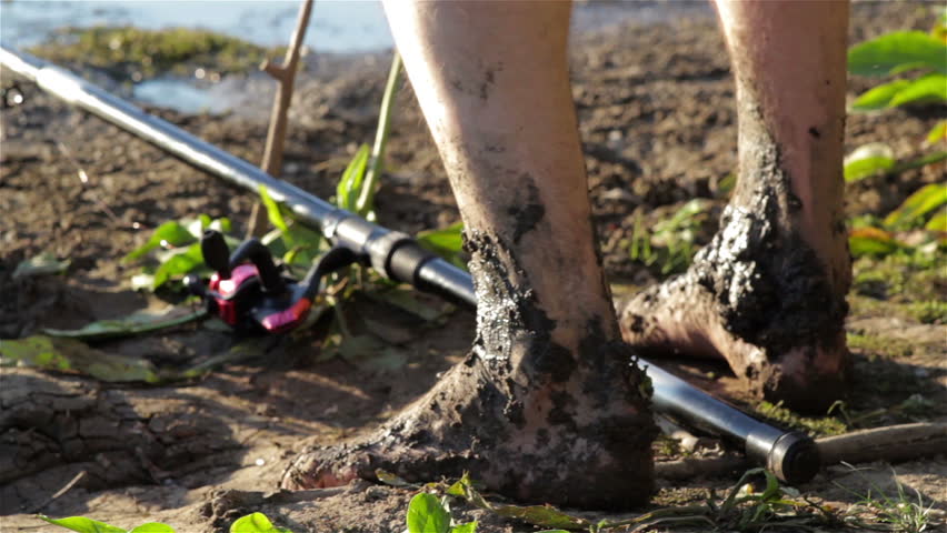 feet in the mud/Human foot in the swamp that squatting fishing