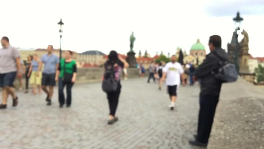 People walking on the Charles Bridge in Prague, blurry view in timelapse