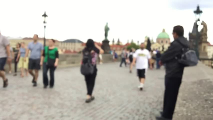 People walking on the Charles Bridge in Prague, blurry view in timelapse