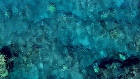 Fast aerial drone footage flying over abstract looking clear water in Honolua Bay, Maui, Hawaii. 