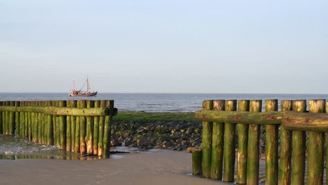 Groyne with a fishing Cutter  in the Background at Wangerooge Island North sea Germany