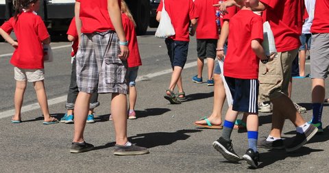 MORONI, UTAH - 4 JUL 2016: 4th July Parade kids grabbing candy. Fourth of July, American celebration for freedom in small rural town. Patriotic flag, high school bands, royalty floats and fire trucks.