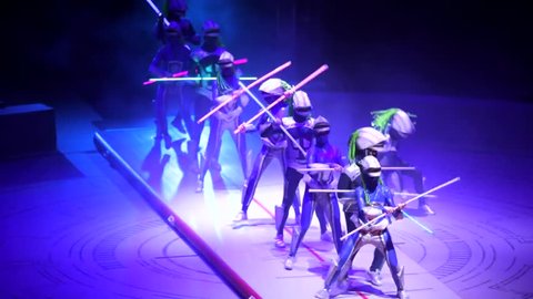 ST. PETERSBURG, RUSSIA - JANUARY 2, 2016: Brothers Zapashny circus, "UFO. Alien Planet Circus" show in Saint Petersburg. In corridor of aliens with neon sticks two acrobats perform difficuls cartheels