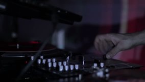 DJ scratching vinyl records and mixing on the Decks at a disco in Nightclub loop video