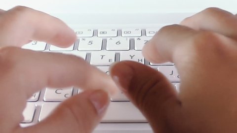 Top view of laptop keyboard with female hands is typing on it 
