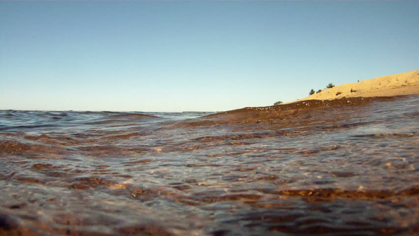 Partially submerged camera watches the waves of Lake Superior come ashore in Marquette, located in the upper peninsula of Michigan