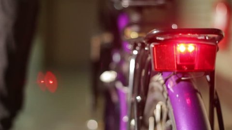 Man ride electric bike.blur.red lamp.violet bicycle