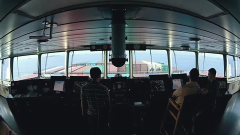 Modern ship bridge view during arrival to port.