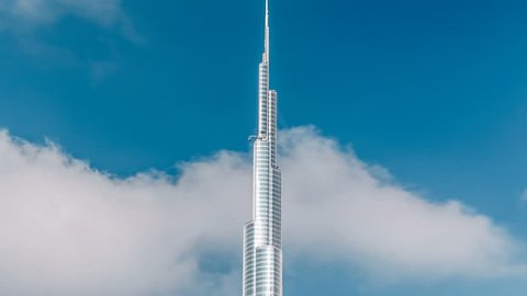 DUBAI - CIRCA JANUARY 2016: The Burj Khalifa among blue sky with clouds and rays of sun light timelapse, tallest building in the world. Dubai, UAE