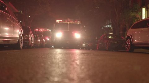 NEW YORK - MAY 15, 2016: FDNY fire trucks with flashing lights standing on street in the city at night. fire department emergency scene