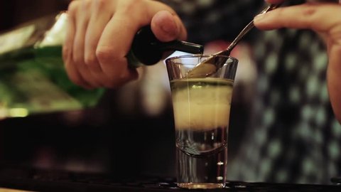 Barman prepares alcoholic cocktail, close up