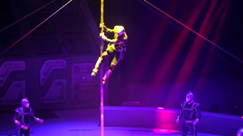 ST. PETERSBURG, RUSSIA - JANUARY 2, 2016: Brothers Zapashny circus, "UFO. Alien Planet Circus" show in Saint Petersburg. Gymnast climbs the pole and goes down spinning around