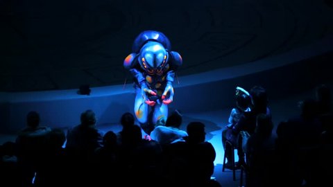 ST. PETERSBURG, RUSSIA - JANUARY 2, 2016: Brothers Zapashny circus, "UFO. Alien Planet Circus" show in Saint Petersburg. Actor in big alien bug costume dances in front of the spectators