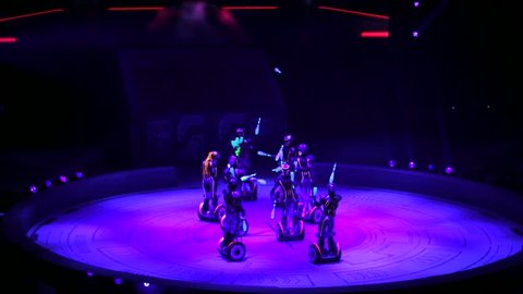 ST. PETERSBURG, RUSSIA - JANUARY 2, 2016: Brothers Zapashny circus, "UFO. Alien Planet Circus" show in Saint Petersburg. Group of alien jugglers on segways in the dark. Amazing show