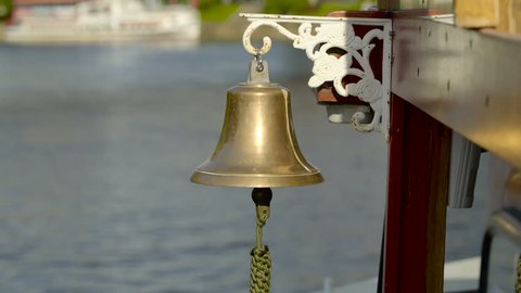 Closer look of the bell on the travelling boat in the river it has golden color with white stainless steel