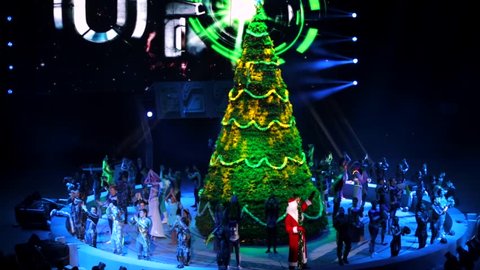 ST. PETERSBURG, RUSSIA - JANUARY 2, 2016: Brothers Zapashny circus, "UFO. Alien Planet Circus" show in Saint Petersburg. Big christmas tree and applauding actors of the show are around it