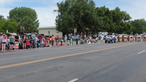 FOUNTAIN GREEN, UTAH - JUL 2016: Rural community parade family train in road. Fourth of July, American celebration for freedom in small rural town. Parade reflects community values and family morals.