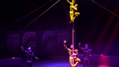 ST. PETERSBURG, RUSSIA - JANUARY 2, 2016: Brothers Zapashny circus, "UFO. Alien Planet Circus" show in Saint Petersburg. Alien gimnasts climb down the pole after demonstrating their skills