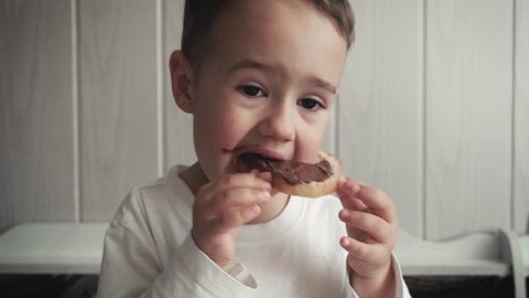 Little boy Funny Eats Bread with Butter