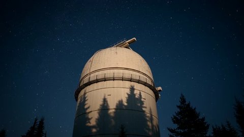 4k star time lapse video with clear night sky and the biggest observatory telescope in an open tower dome,  Astronomical observatory of Rozhen, Bulgaria, July 15, 2016.