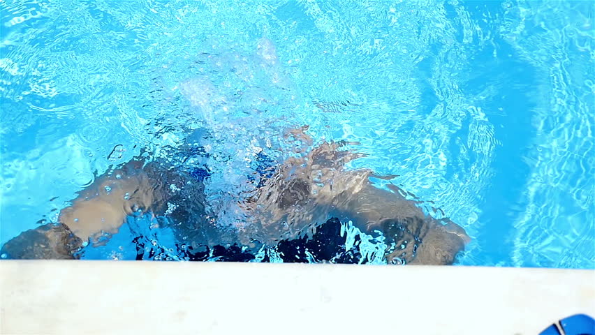 Swimmer going out of an open air pool, slow motion