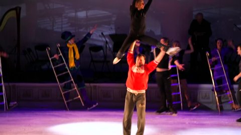 MOSCOW, RUSSIA - JANUARY 12, 2016: Full rehearsal of theater of ice miniatures perfomance anniversary program "We are 30". Man holds lady with ladder above his head and spins around