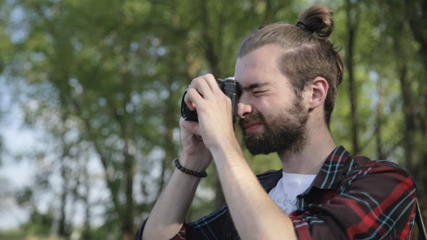 Man taking pictures on film camera