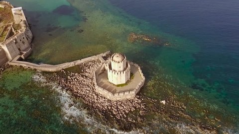 Aerial view from Methoni's Castle in Peloponnese, Greece. The fortress is located by the wonderful sea with rich coloured water. Camera orbits with the old Lighthouse centered.
