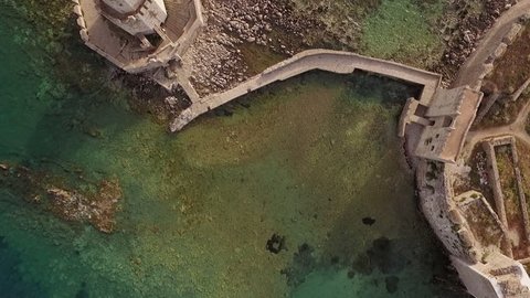 Aerial view from Methoni's Castle in Peloponnese, Greece. The fortress is located by the wonderful sea with rich coloured water. Vertical angle in diagonal motion.