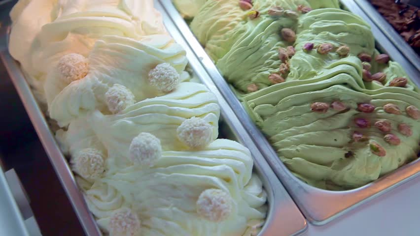 Different types of ice cream in the fridge close-up. 
