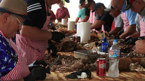 FOUNTAIN GREEN, UTAH - JUL 2016: BBQ cooked lamb pulled from bones for sandwiches. Annual rural community celebration sheep industry. BBQ pit cooking of lambs and making of thousands of sandwiches.