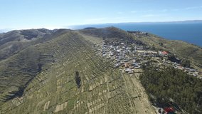 4K Aerial shot of Isla Del Sol and village at Titicaca Lake forward move