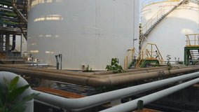 Oil storage tank in industrial plant , smooth panning video
