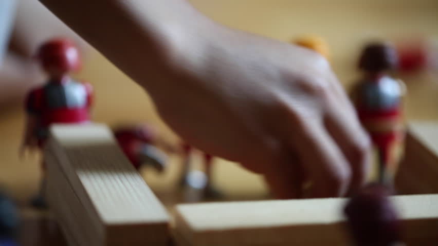 Young boy playing with toys. 8 year old boy playing with toys in his room. Child playing with toys. Kid playing with toy alone by himself