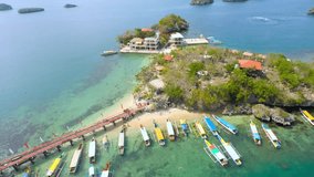 aerial drone shot of islands with outrigger boats in the Philippines