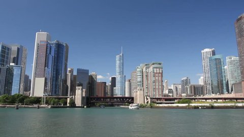 Time lapse shot with a smooth motion view from a boat as it enters the mouth of the Chicago River, passing under bridges and through skyscrapers into the center of Chicago