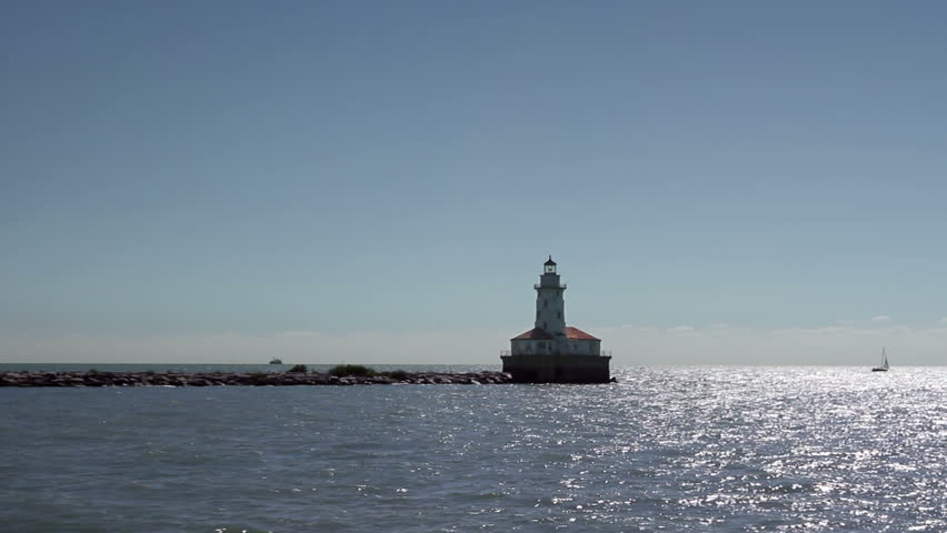A lighthouse in Lake Michigan (Chicago Harbor Lighthouse) as seen from a boat speeding by it