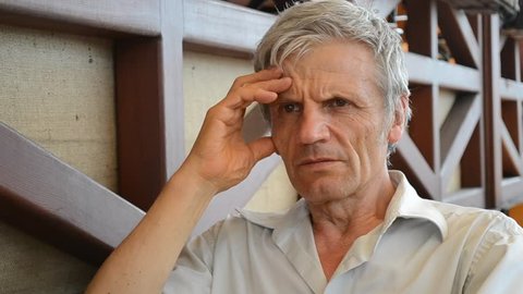 elderly man serious think, reflects