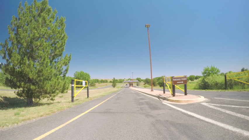 Car driving on paved road in Chatfield State Park.-POV point of view.