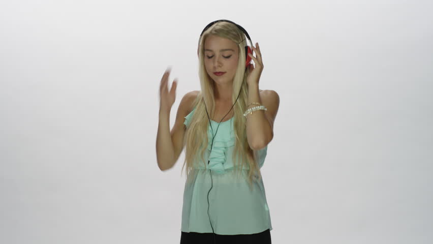 Attractive girl listening to music on headphones