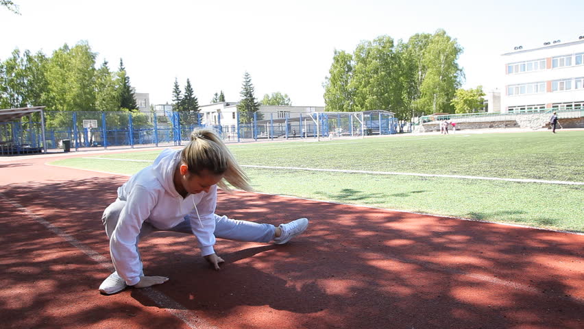 young beauty girl do exercises at the stadium, outdoor
