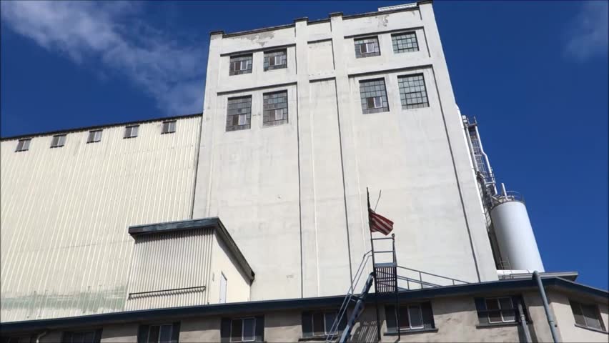 industrial building with american flag waving in wind