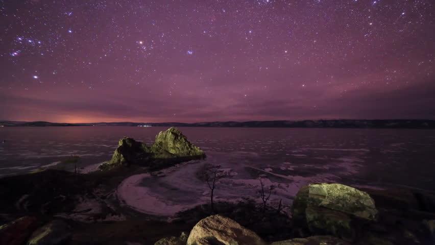 Starry night over the island Olkhon. Burkhan Cape, Olkhon island, Lake Baikal, Irkutsk region, Russia. Full HD

